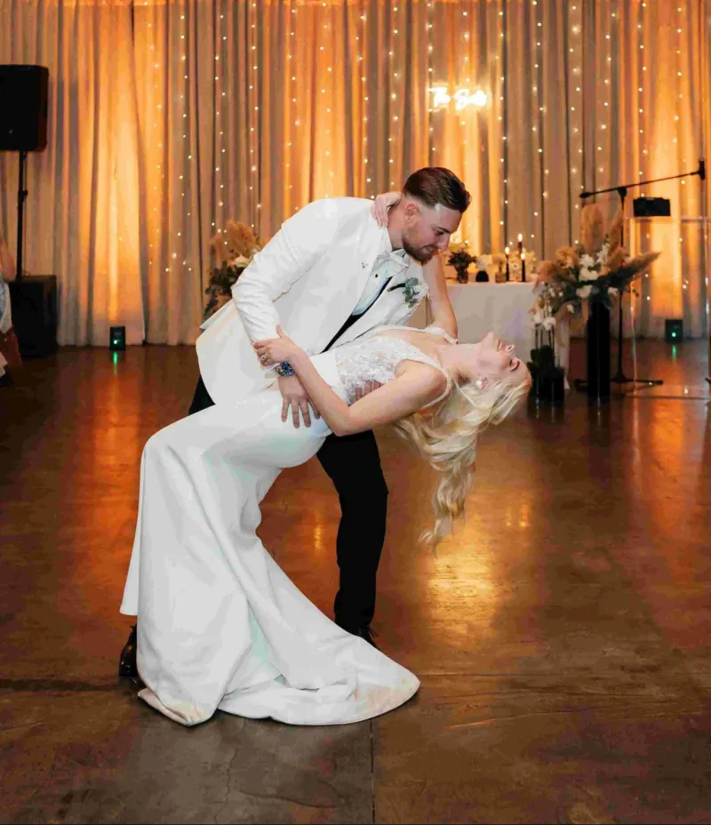groom dipping bride during first dance at wedding reception
